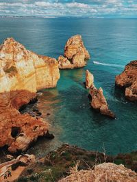 Rocks on shore by sea