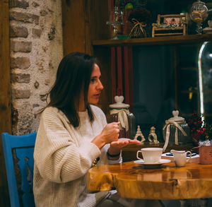 Woman sitting on table at cafe