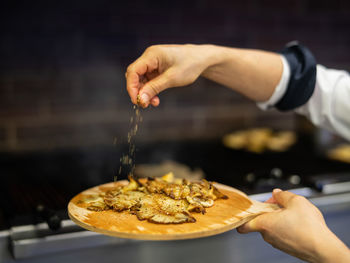 Cropped hand of person preparing food