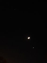Low angle view of moon against sky at night