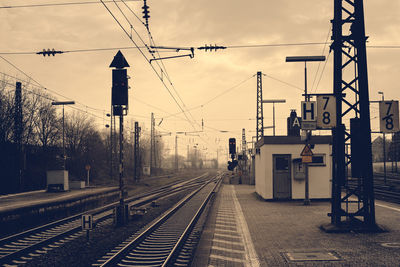 Railroad tracks at station against sky