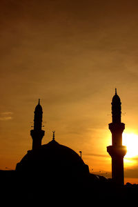 Low angle view of silhouette building against sky during sunset