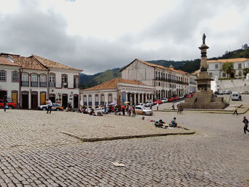 View of town square against cloudy sky