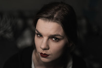 Portrait of a young woman in the shadow with sensual makeup