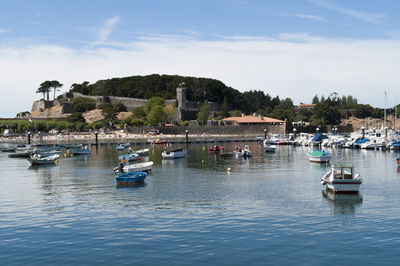 Boats moored on lake by fort