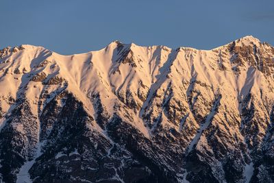 Scenic view of snowcapped mountains against clear sky