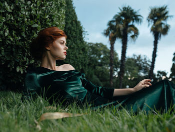 Young woman looking away on field