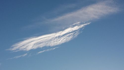 Low angle view of vapor trail in blue sky