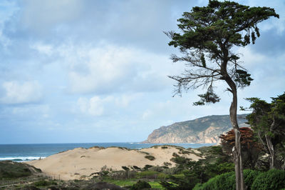 Scenic view of sea against cloudy sky