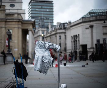 Cloth hanging on metal pole at town square in city