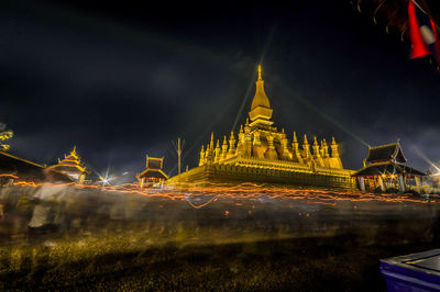 Panoramic view of illuminated buildings against sky at night