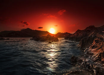 Scenic view of sea against romantic sky at sunset