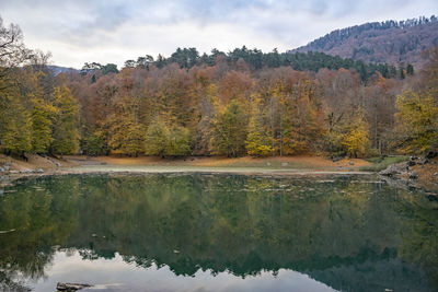 Reflection of trees in lake against sky during autumn