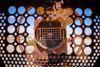 Directly below shot of metal grate window