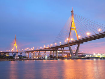 Illuminated suspension bridge over river