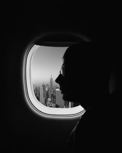 Close-up of man looking through window