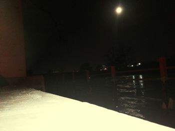 Illuminated lights against sky at night