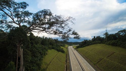 Road amidst trees against sky