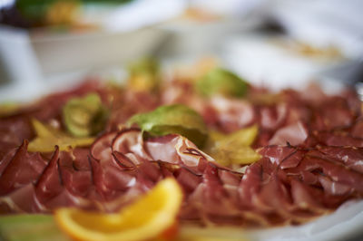 Close-up of chopped fruit in plate on table