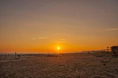 Scenic view of beach against sky during sunset