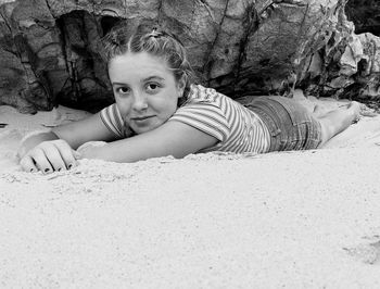 Portrait of girl lying down on beach