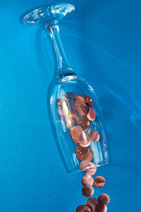 High angle view of bottle on blue glass