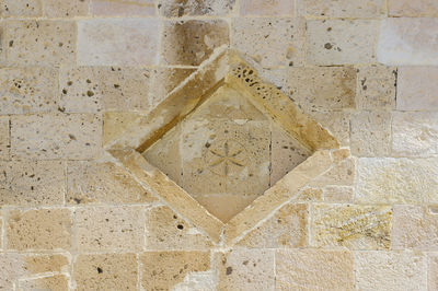 Close-up of stone wall with tiled floor