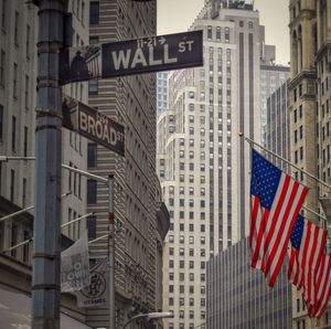 Low angle view of flag against buildings in city