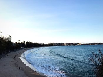 View of beach against clear blue sky