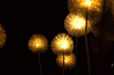 Low angle view of illuminated christmas lights against sky at night