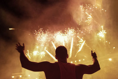 Low angle view man looking at firework display