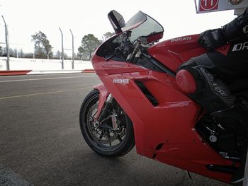 Close-up of motor scooter on road