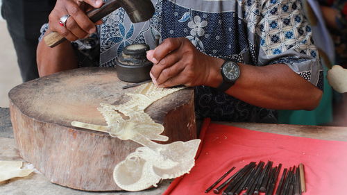 Midsection of man working in workshop