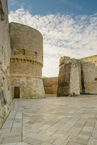 View of old ruin building against cloudy sky