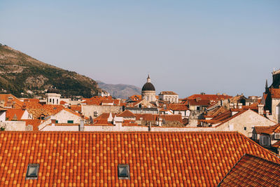 Houses in town against clear sky