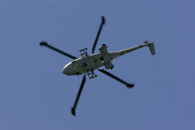 Low angle view of helicopter flying in sky