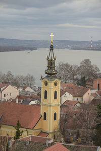 Tower amidst buildings in city against sky