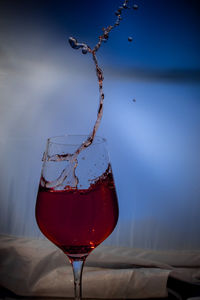 Close-up of red wine glass on table