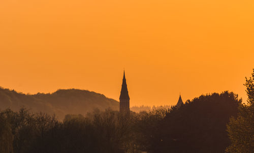 Silhouette of temple against sky during sunset