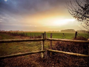 Scenic view of field against sky during sunset