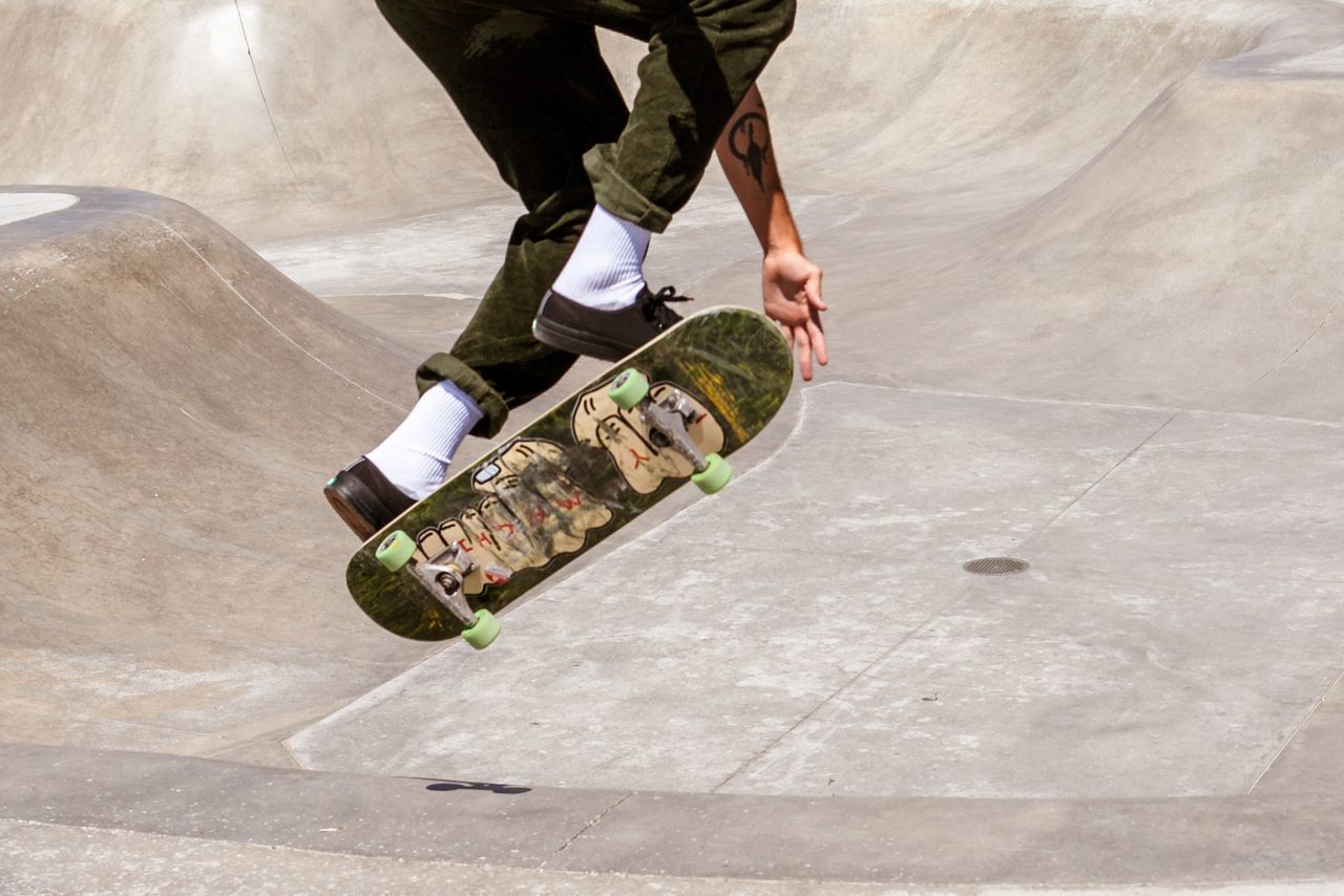 LOW SECTION OF MAN WITH SKATEBOARD