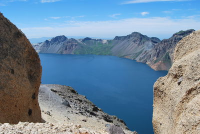 Scenic view of mountain against blue sky