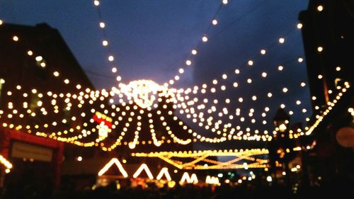 Illuminated lights against sky at night