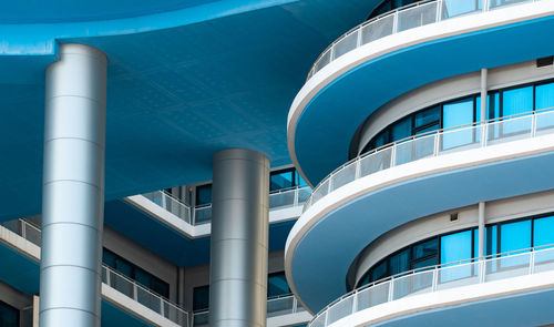 Low angle view of modern building against blue sky