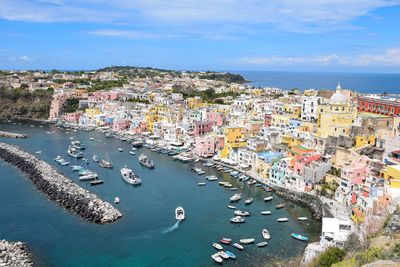 High angle view of townscape by sea against sky