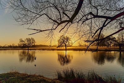 Scenic view of lake against sky during sunset