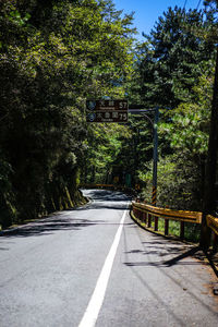 Road amidst trees in forest