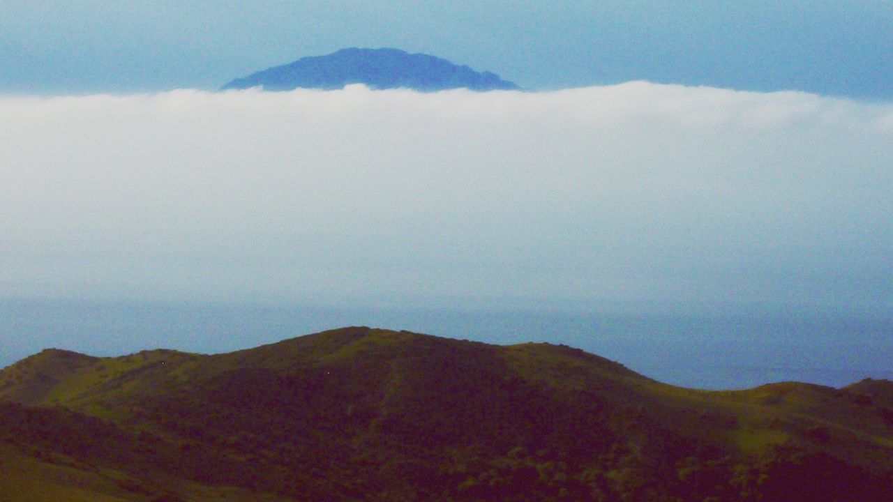 mountain, tranquil scene, scenics, tranquility, mountain range, beauty in nature, sky, landscape, nature, idyllic, non-urban scene, cloud - sky, remote, fog, cloud, majestic, physical geography, outdoors, day, no people