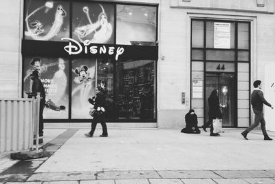 People walking in front of building