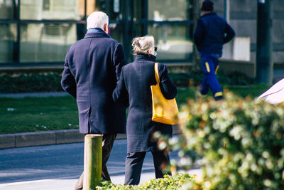 Rear view of people walking outdoors